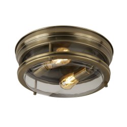 Glasgow Ø35 Antikes Messing badezimmerlampe Von Searchlight - Sie vereint robustes Design mit stilvoller Funktionalität und spendet dank sichtbarer Leuchtmittel und klarem Glasschirm ein warmes, einladendes Licht.