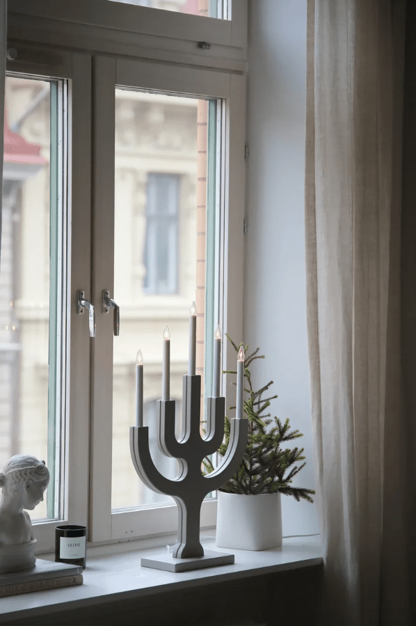 Sapin 5L Greige Von Markslöjd - Seine gro&szlig;z&uuml;gige Gr&ouml;&szlig;e macht ihn zu einem dekorativen Blickfang, besonders in gr&ouml;&szlig;eren Fenstern, wo die f&uuml;nf Kerzen an dunklen Winterabenden ein warmes und stimmungsvolles Licht verbreiten.