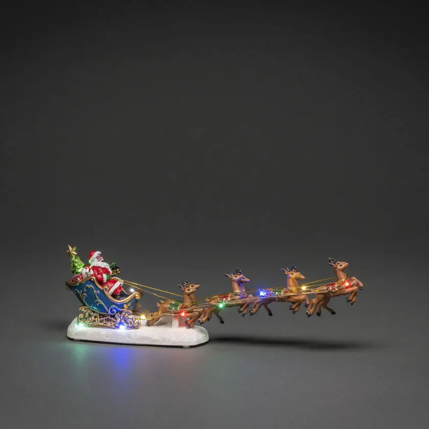 Weihnachtsmann Mit Rentieren 14cm Mehrfarbig Von Konstsmide - Elegante Weihnachtsdekoration mit Weihnachtsmann im Schlitten und Rentieren, beleuchtet von bunten LED-Lichtern.