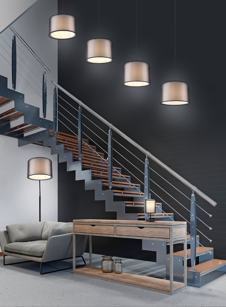 Burton Schwarz stehlampe Von Trio Lighting - Die moderne Kombination aus einem inneren weißen Stoffschirm und einem äußeren transparenten schwarzen Kunststoffschirm wirkt individuell und erfrischend zugleich und lässt sich in moderne Wohnwelten integrieren.