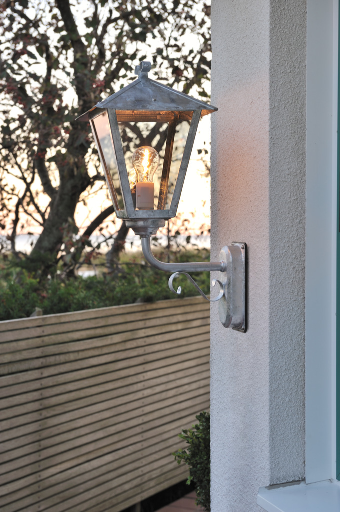 Benu Verzinkter Stahl außenlampe Von Konstsmide - Die klassische Laternenform und die robusten Materialien machen die Lampe zur perfekten Wahl f&uuml;r alle, die in Eingangsbereichen oder langen Fluren eine einladende Atmosph&auml;re schaffen m&ouml;chten.