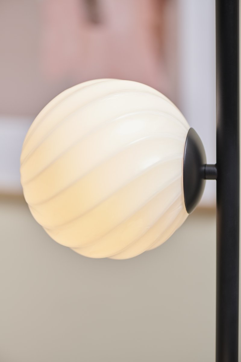 Twist Schwarz stehlampe Von Halo Design - Der mattschwarze Rahmen und das sanfte Licht der Lampe schaffen eine perfekte Balance zwischen Modernit&auml;t und W&auml;rme.