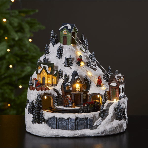 Alpville 25cm Mehrfarbig Von Star Trading - Wundersch&ouml;ne Weihnachtsdekoration in Form einer dekorativen Winterlandschaft mit Seilbahn, Skifahrern und Bahnhof mit rotierendem Zug.
