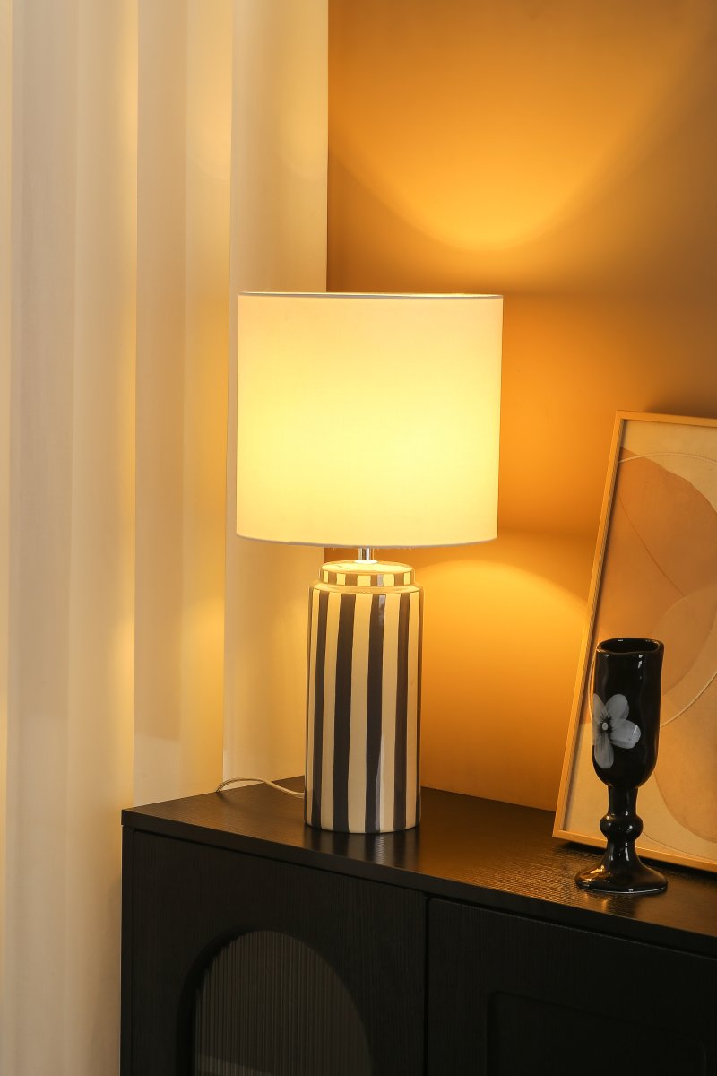 Faro 50cm Grau/Weiß tischlampe Von Nordic Lighting - Der Lampenfu&szlig; aus Keramik besticht durch seine cremewei&szlig;e Basis und graue Streifen, die einen lebendigen und zugleich harmonischen Eindruck erzeugen.